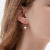 STMG Pearl Dangle Earrings in silver on ear