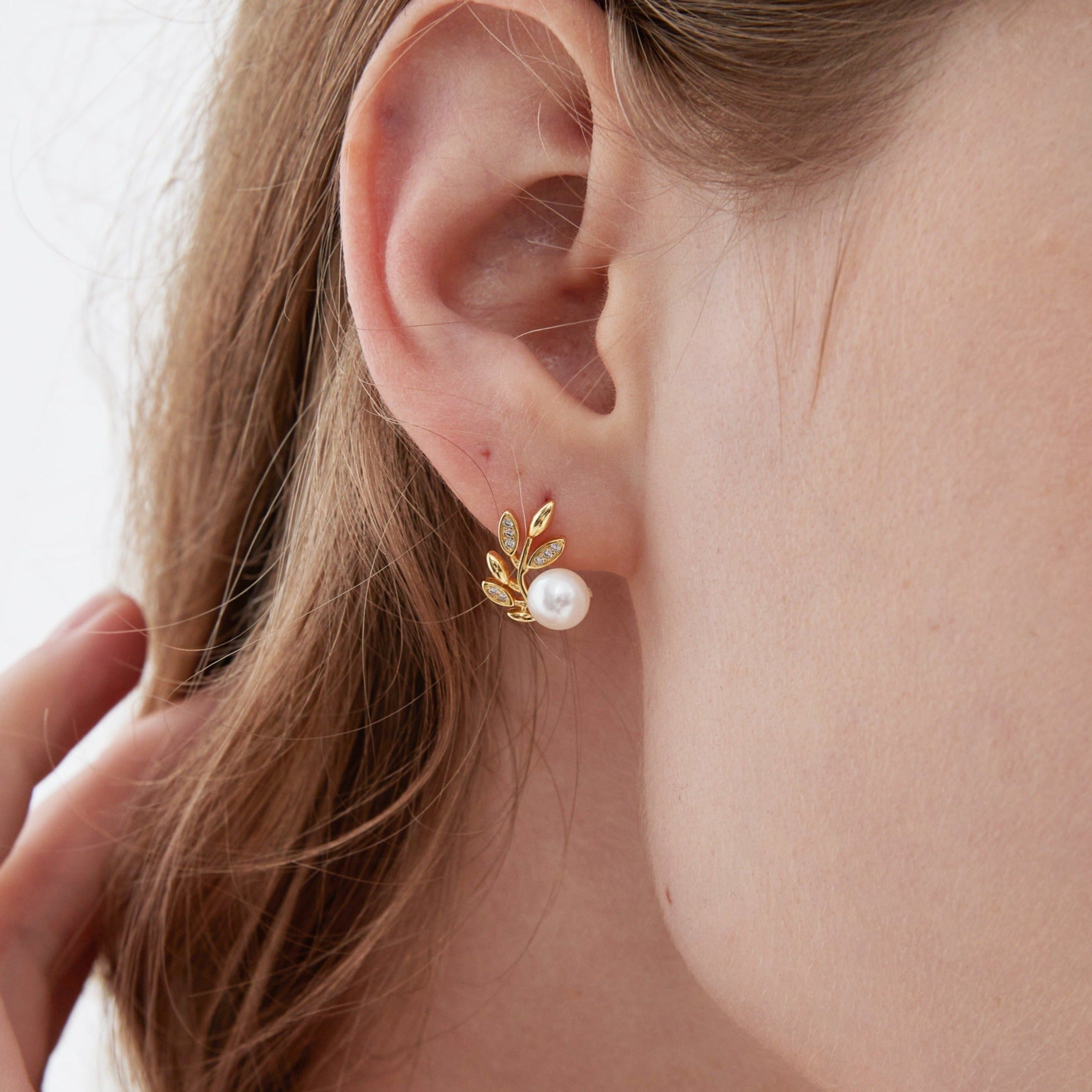 STMG Natural Pearl on Olive Leaf Stud Earrings in gold on ear