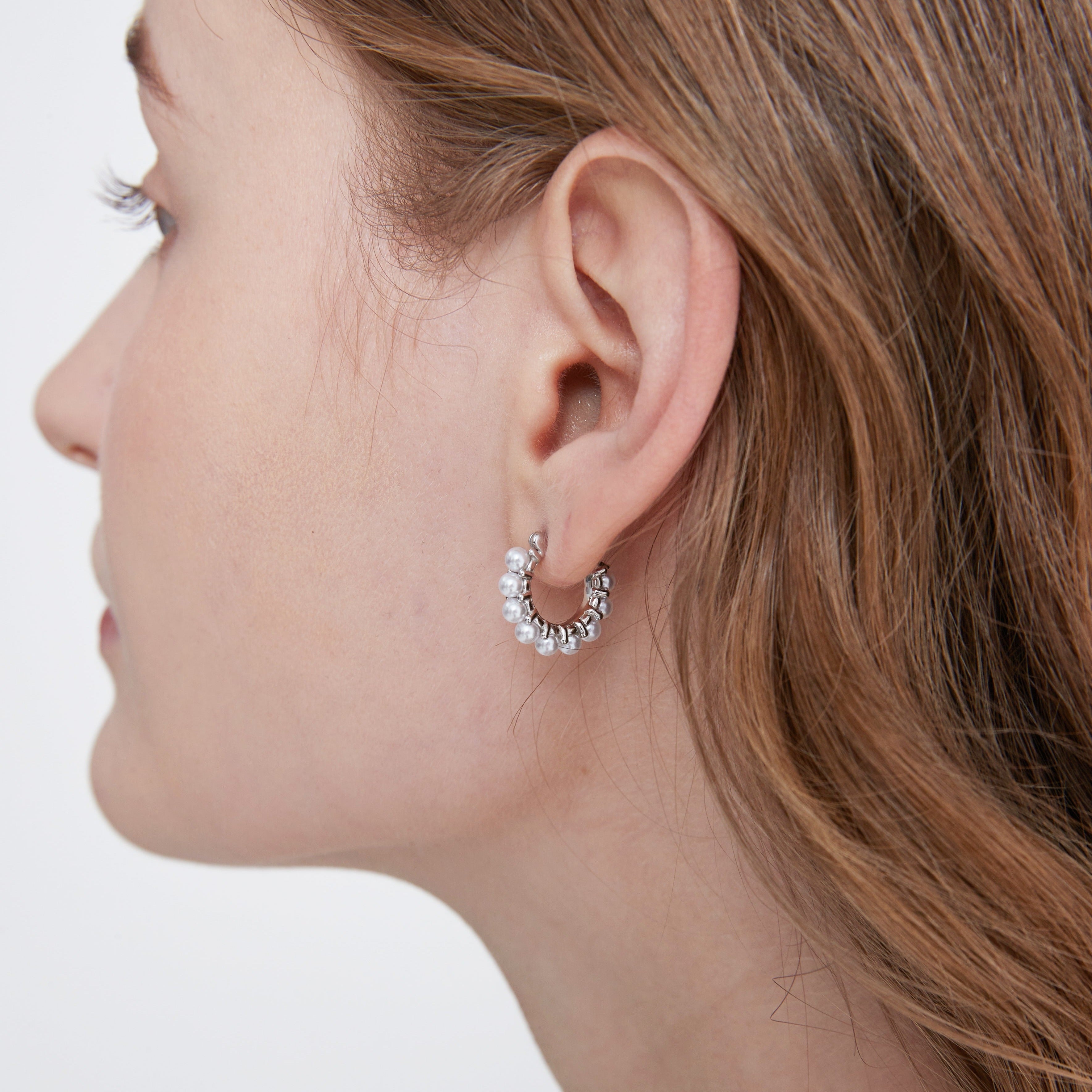 STMG Minimalist Pearl Hoops in silver on ear