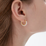 STMG Minimalist Pearl Hoops in gold on ear