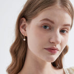 STMG Natural Pearl Dangle Earrings on ear