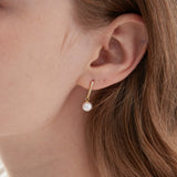 STMG Natural Pearl Dangle Earrings on ear