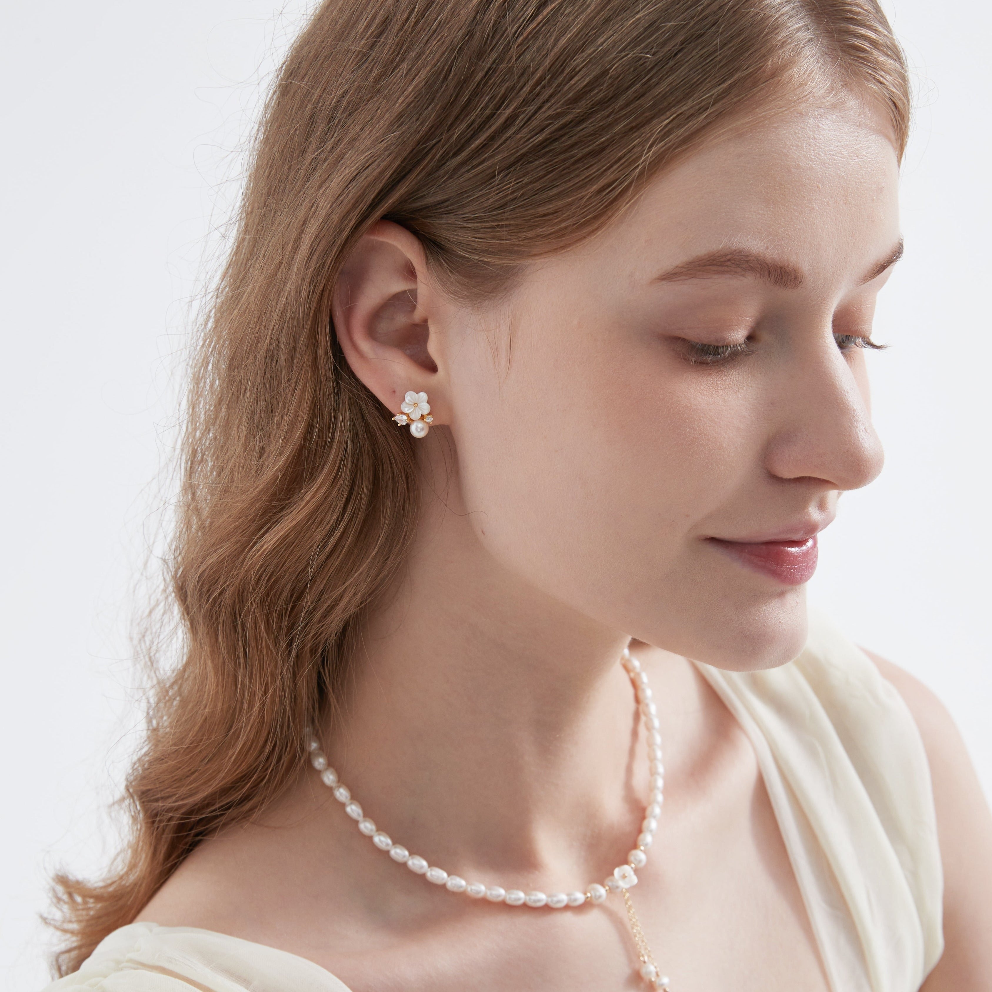 STMG Pearl Flower Stud Earrings on ear with matching necklace on neck