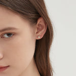 STMG Snowflake Stud Earrings on ear