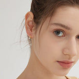 Bowknot Dangle Star Hoops in gold on ear