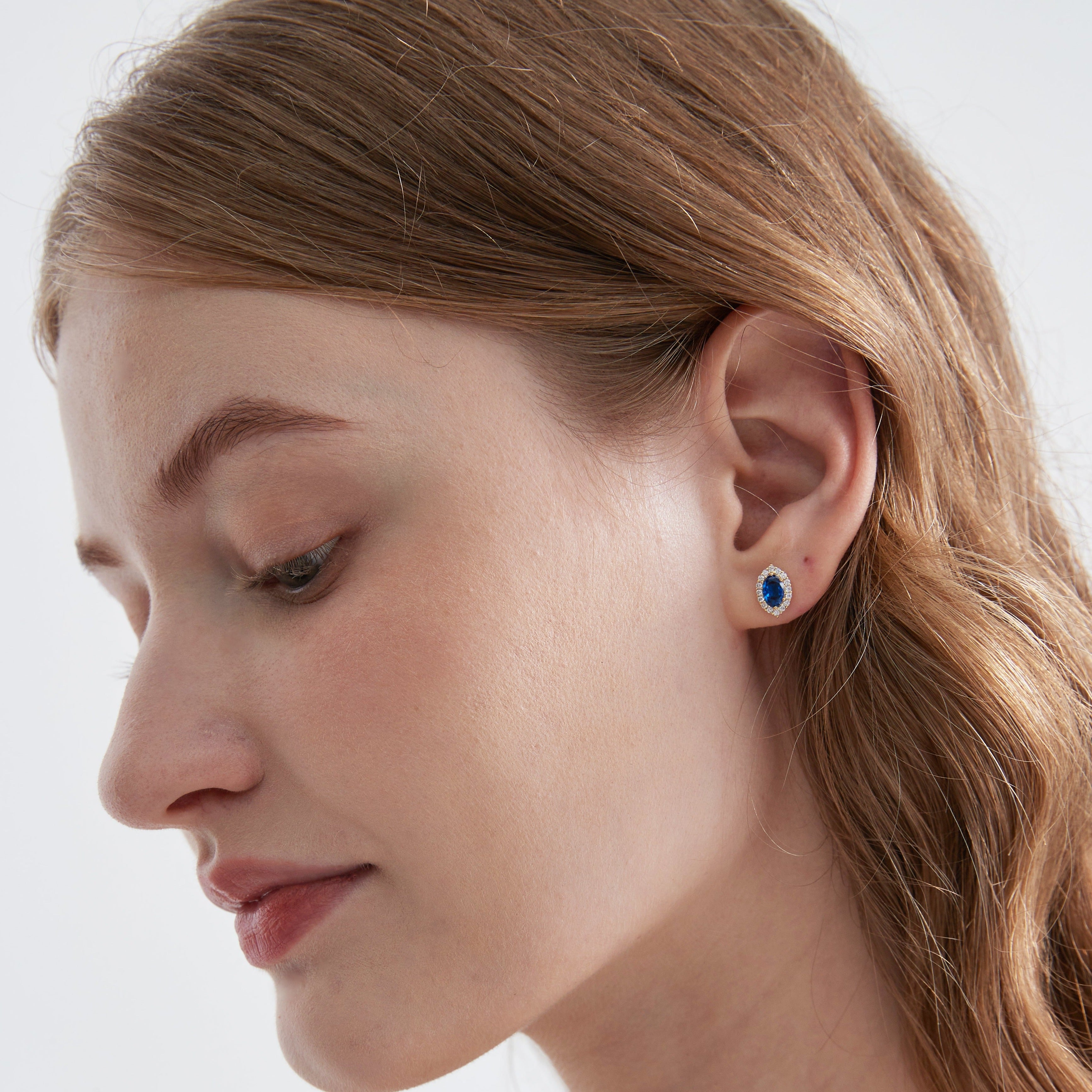 Blue Sapphire Stud Earrings on ear