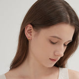 STMG Geometric Wave Hoops in gold on ear