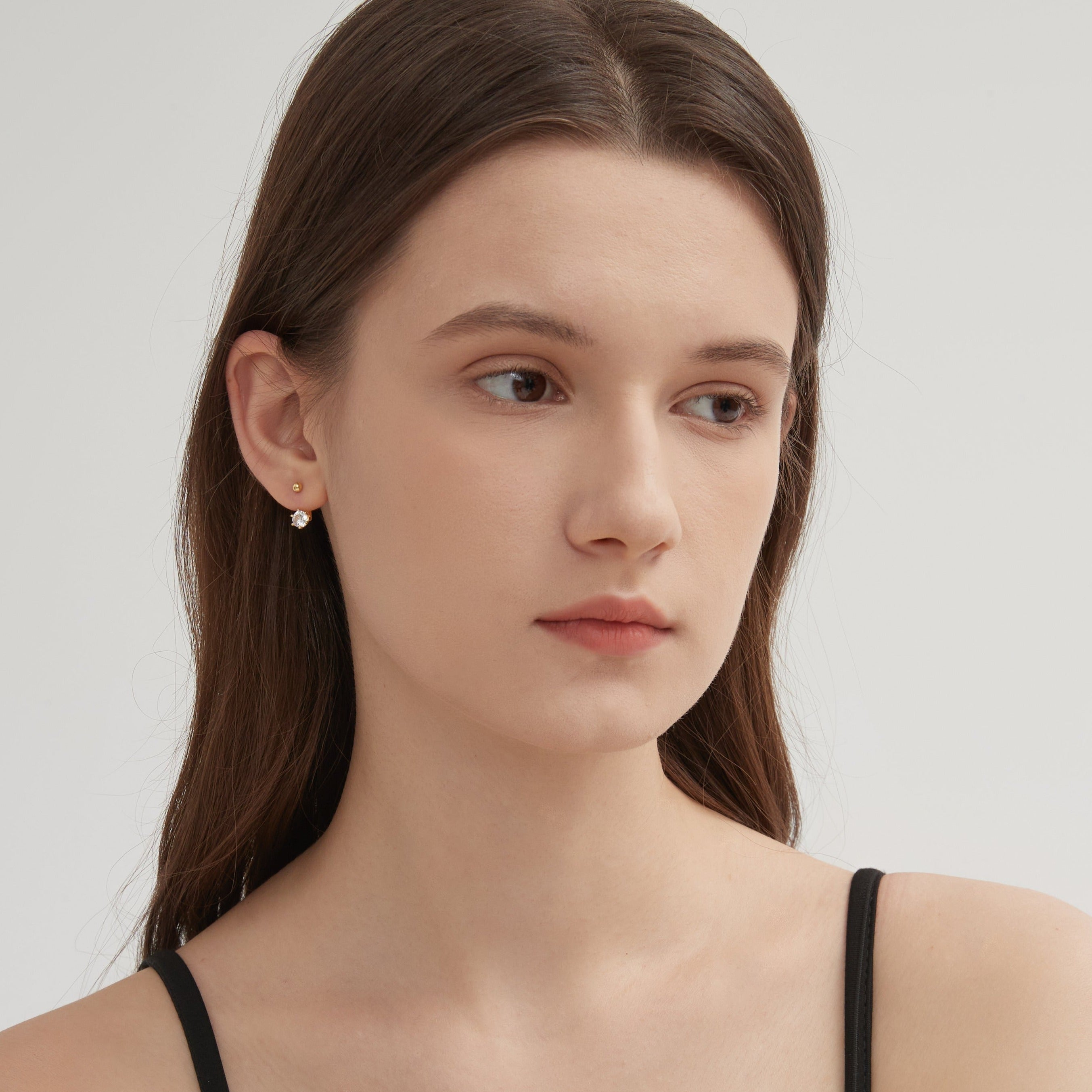 Diamond Stud Earrings in gold on ear