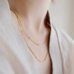 STMG Minimalist Beaded Choker Necklace in gold on neck